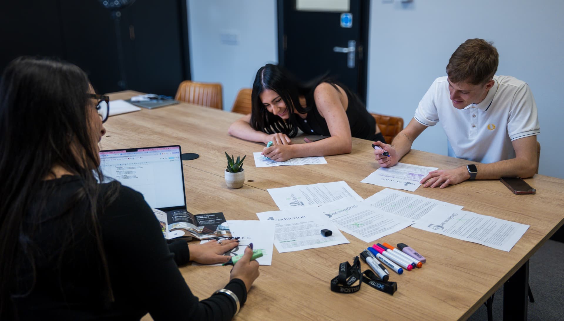 The Dellsche team reviewing and marking up project documents together
