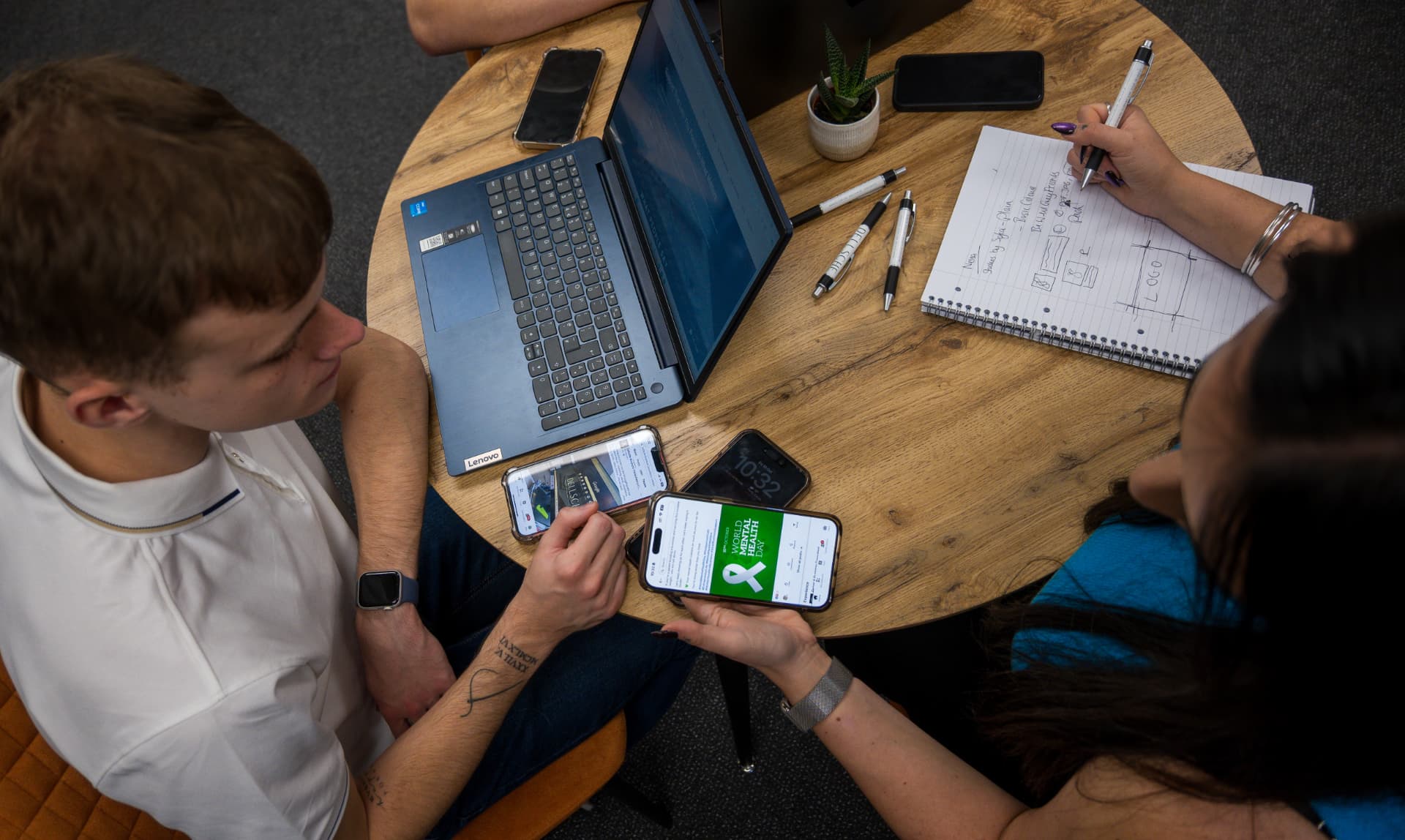 Planning social media and marketing content on phones and a laptop